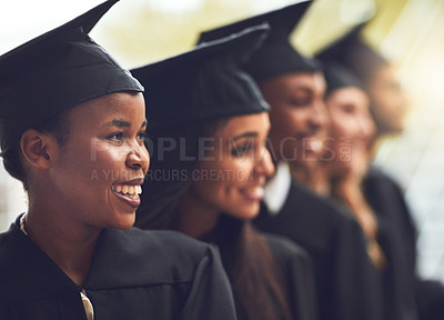 Buy stock photo Shot of a group of fellow students standing in a row on graduation day