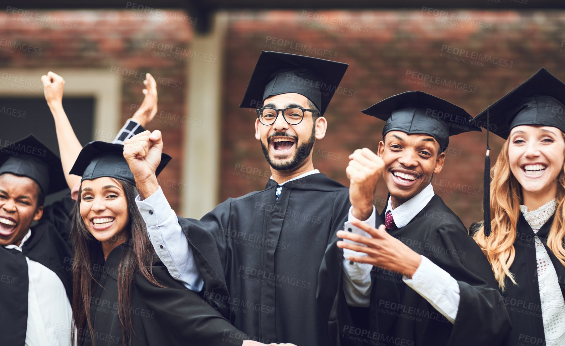 Buy stock photo Shot of a group of fellow students standing together on graduation day