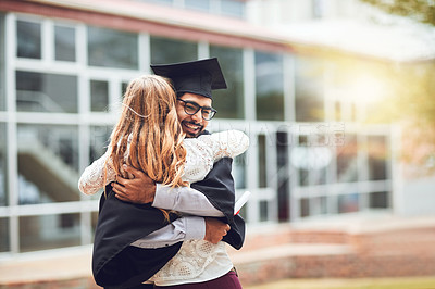 Buy stock photo Rearview shot of a woman hugging a student on graduation day
