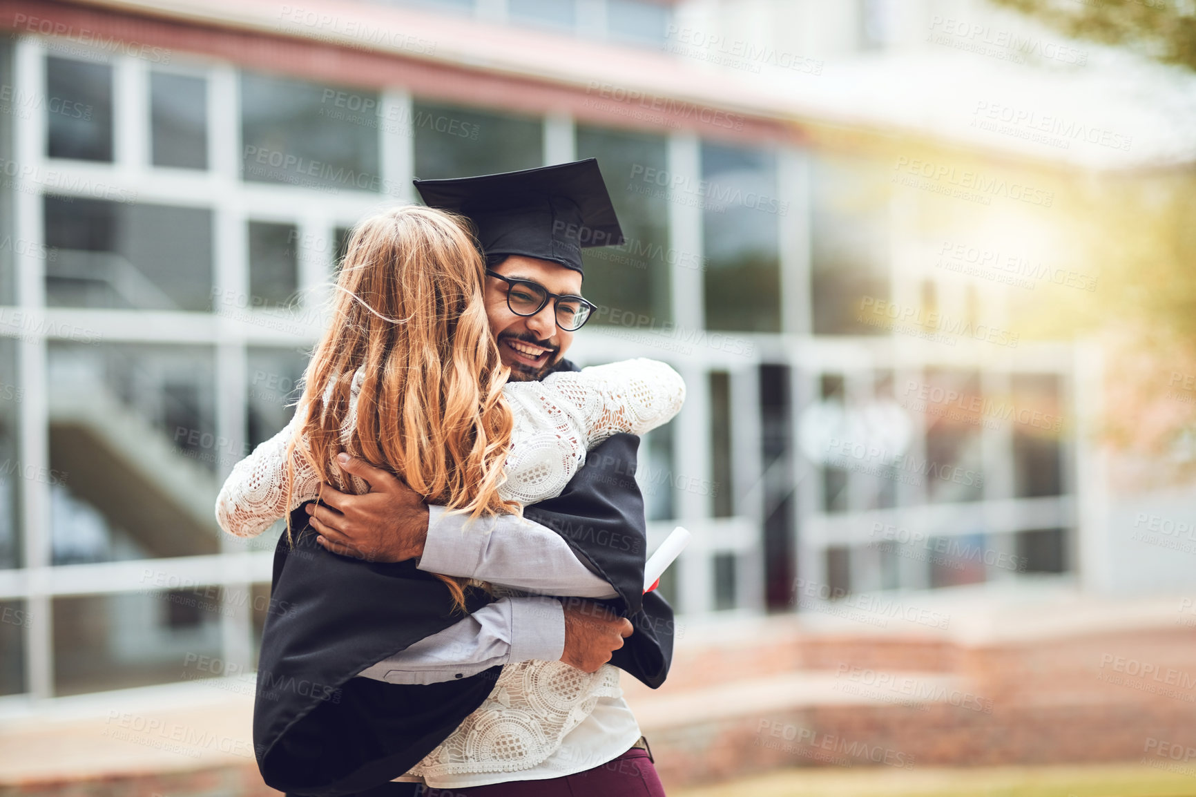 Buy stock photo Graduation, couple and happy or hug for success outdoor on campus with support, certificate and ceremony. Graduate, student and person with diploma for university achievement and academic milestone