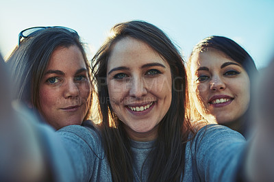 Buy stock photo Portrait of a group of women taking a selfie together outdoors