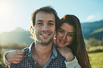 Buy stock photo Portrait of a young couple bonding together outdoors