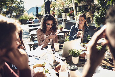 Buy stock photo Shot of creative employees having a breakfast meeting outside