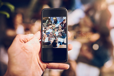 Buy stock photo Cropped shot of a man taking a picture of colleagues having a business lunch