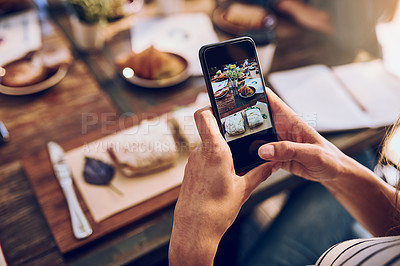Buy stock photo Cropped shot of a woman taking a picture on her phone of her food