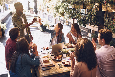 Buy stock photo Shot of a group of creative workers having a meeting over lunch in a cafe