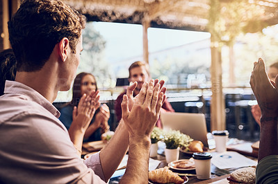Buy stock photo Shot of a group of colleagues clapping hands in a lunch meeting