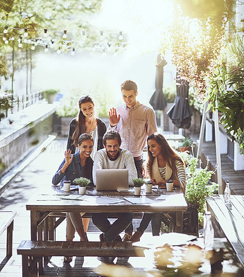 Buy stock photo Shot of a team of colleagues making a video call with  laptop during a meeting at an outdoor cafe