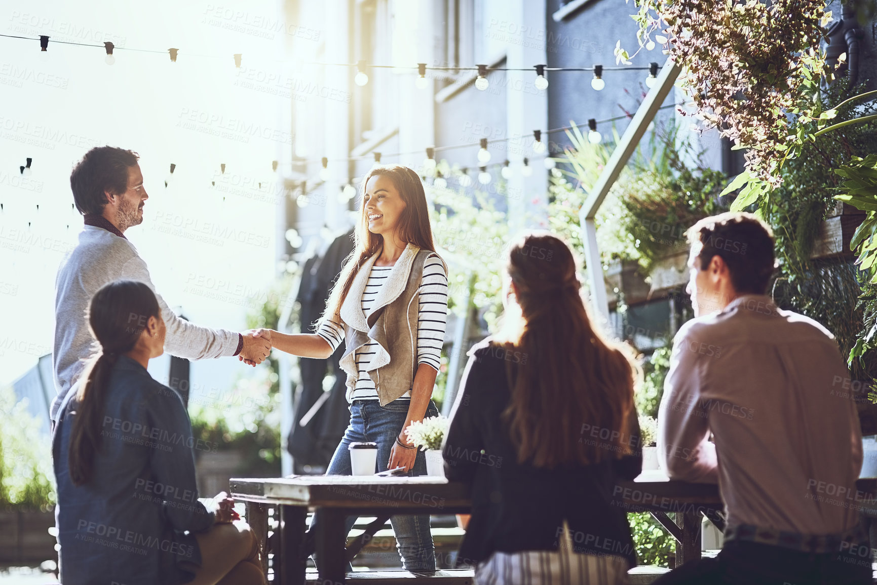 Buy stock photo Business people, greeting and handshake in meeting at cafe for welcome, b2b networking or remote work outdoor. Team, employee and shaking hands for onboarding, partnership deal or happy for agreement