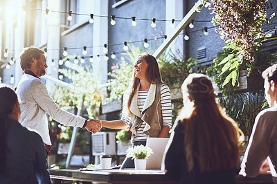 Buy stock photo Business people, happy and handshake in meeting at cafe for welcome, b2b networking and remote work outdoor. Group, employees and shaking hands for onboarding, partnership and laughing for agreement