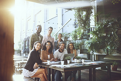 Buy stock photo Portrait of a team of colleagues using a laptop together during a meeting at an outdoor cafe