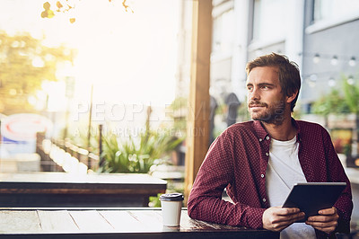 Buy stock photo Cropped shot of a handsome young using his digital tablet outside