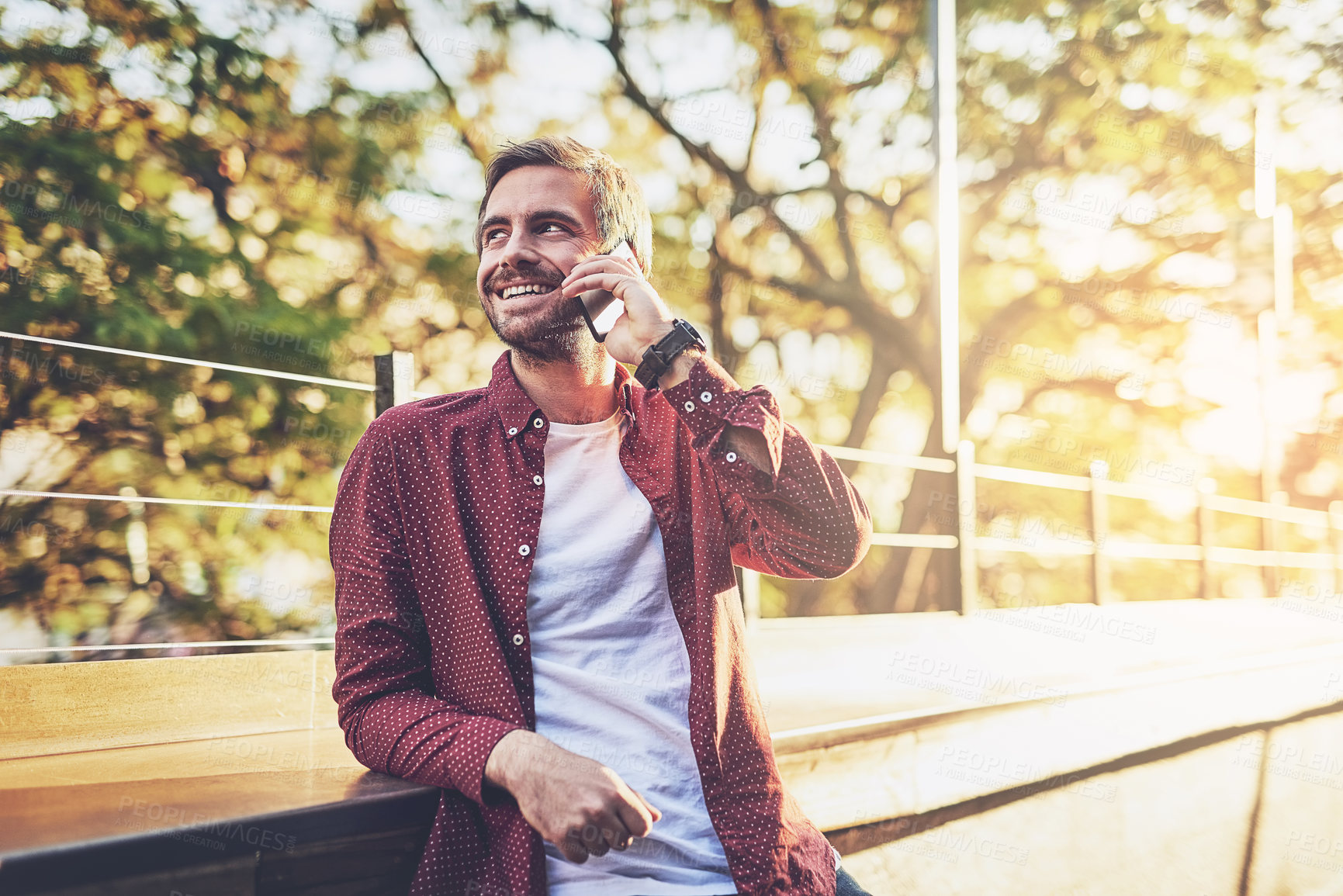 Buy stock photo Cropped shot of a handsome man talking on his cellphone