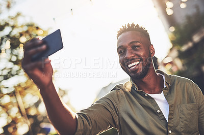 Buy stock photo Cropped shot of a handsome young man taking a selfie outside