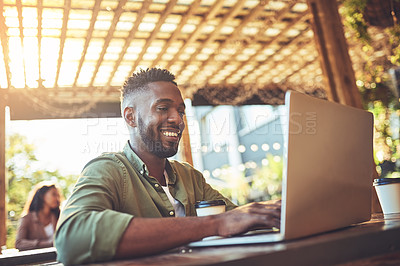Buy stock photo Cropped shot of a young man using a laptop in a coffee shop