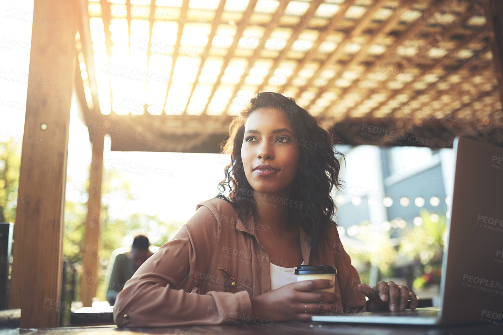 Buy stock photo Cropped shot of a young woman using a laptop in a coffee shop