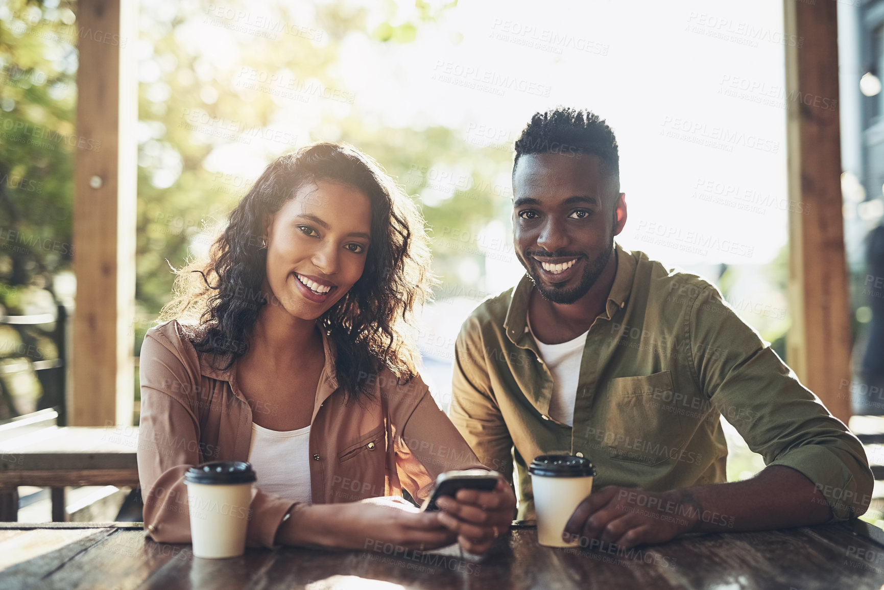 Buy stock photo Smile, portrait and couple in coffee shop with phone, bonding and romantic date with online app. Happy, man and woman in cafe with drink, smartphone and relax together at casual meeting in Brazil