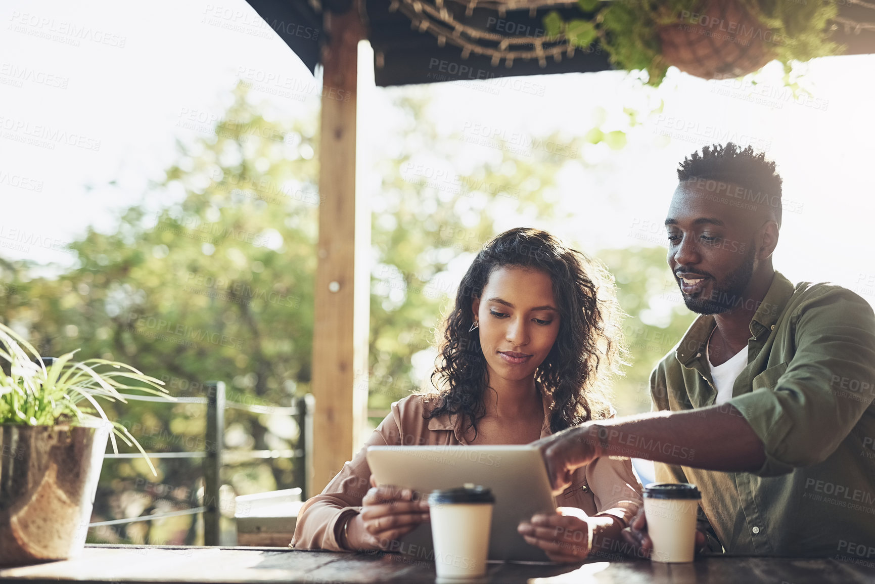 Buy stock photo Coffee, conversation and couple with tablet in cafe for social media, post and relationship update. Happy, woman and man with technology in restaurant for love, bonding and digital communication