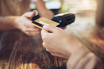 Buy stock photo Cropped shot of a customer making a card payment in a coffee shop
