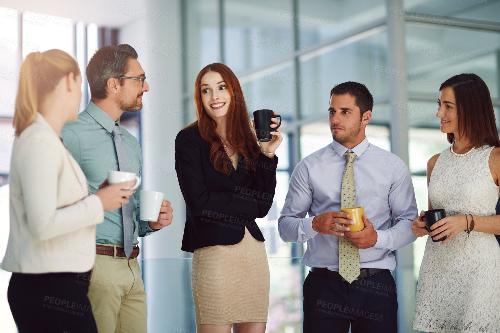 Buy stock photo Shot of colleagues having a discussion and drinking coffee in a modern office