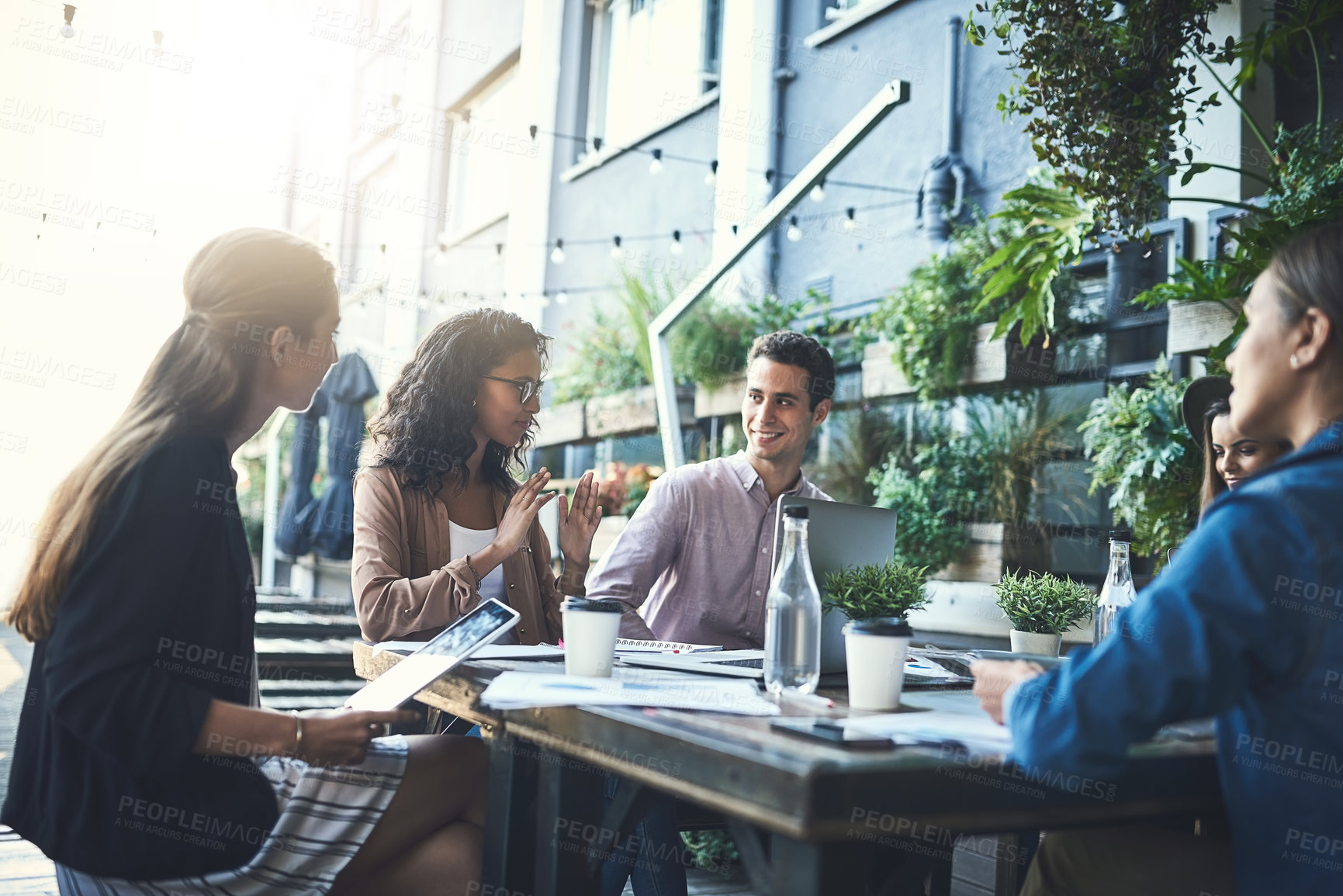 Buy stock photo Shot of a group of designers having a meeting at a coffee shop