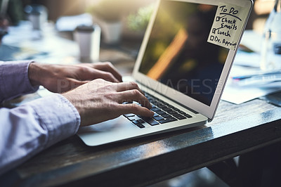 Buy stock photo Closeup shot of an unrecognisable businessman working on a laptop at a cafe