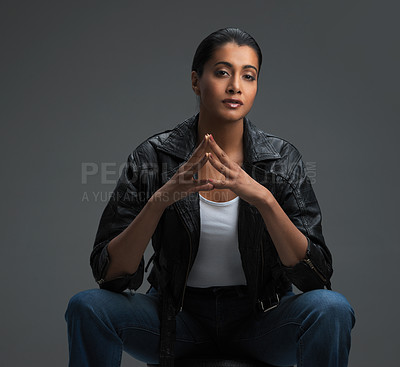 Buy stock photo Studio shot of a beautiful young woman posing against a dark background