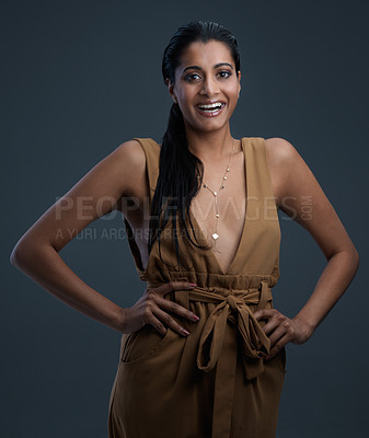 Buy stock photo Studio shot of a beautiful young woman posing against a dark background