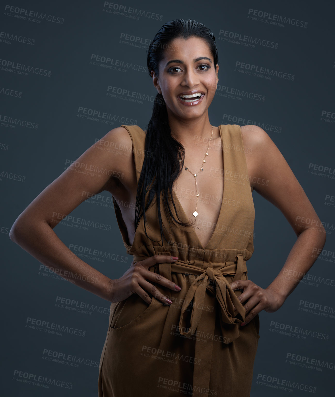 Buy stock photo Studio shot of a beautiful young woman posing against a dark background