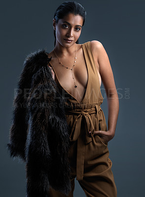 Buy stock photo Portrait, woman and fashion with wardrobe, streetwear and fancy fur jacket on dark background. Female person, style and trendy in studio as edgy or casual with outfit, clothes and confidence in India