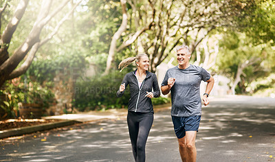 Buy stock photo Shot of a mature couple out jogging on a sunny day