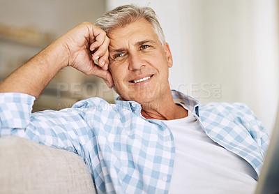 Buy stock photo Handsome mature man relaxing on a sofa, casual, carefree and happy at home. Senior male enjoying the pleasure of retired life, satisfied and stressless. Older guy thinking, smiling and daydreaming 