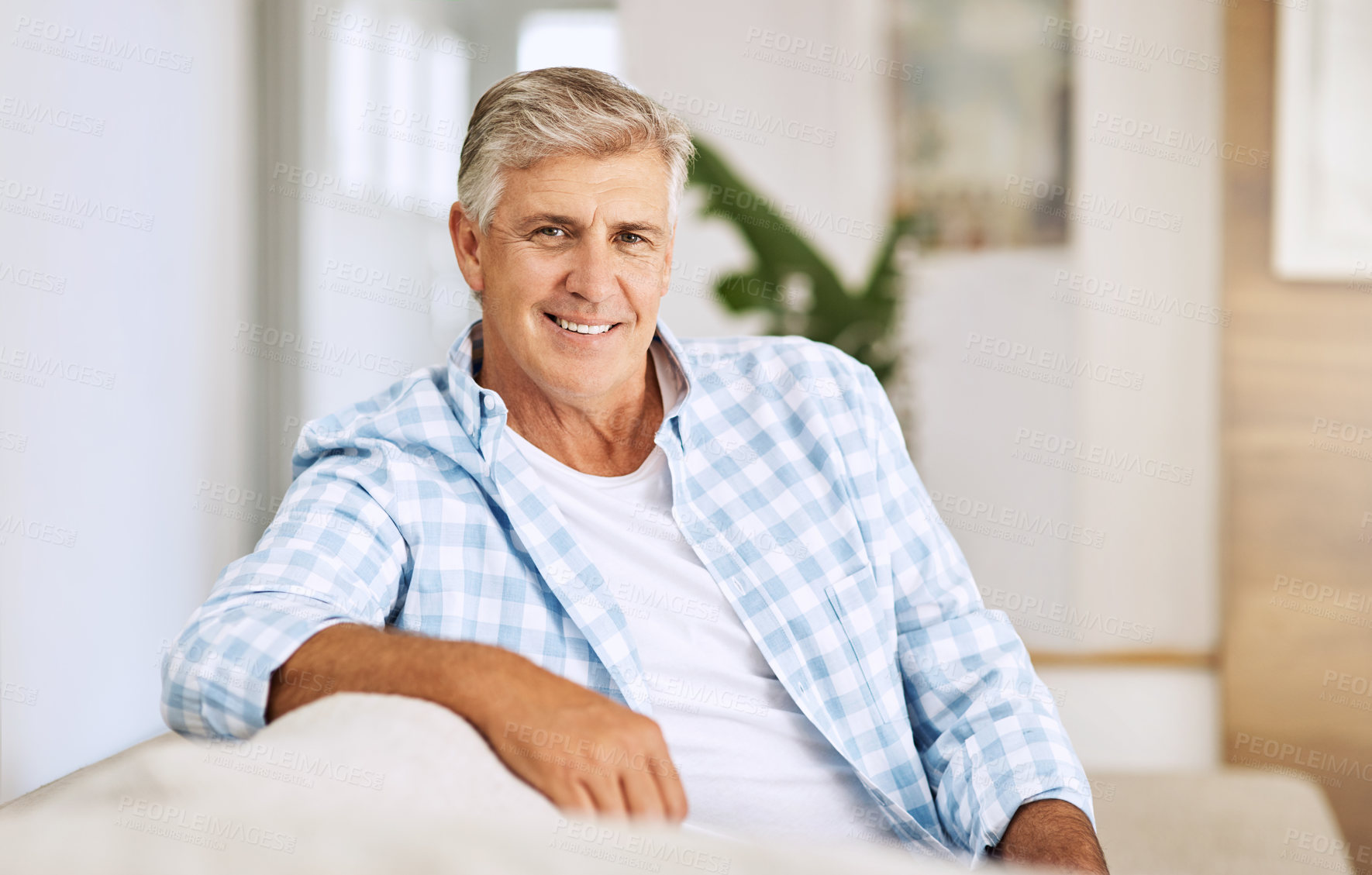 Buy stock photo Portrait, relax and mature man on couch, smile and weekend break with retirement, calm and peaceful in living room. Face, senior person or happy guy on sofa, chilling and casual with joy and cheerful