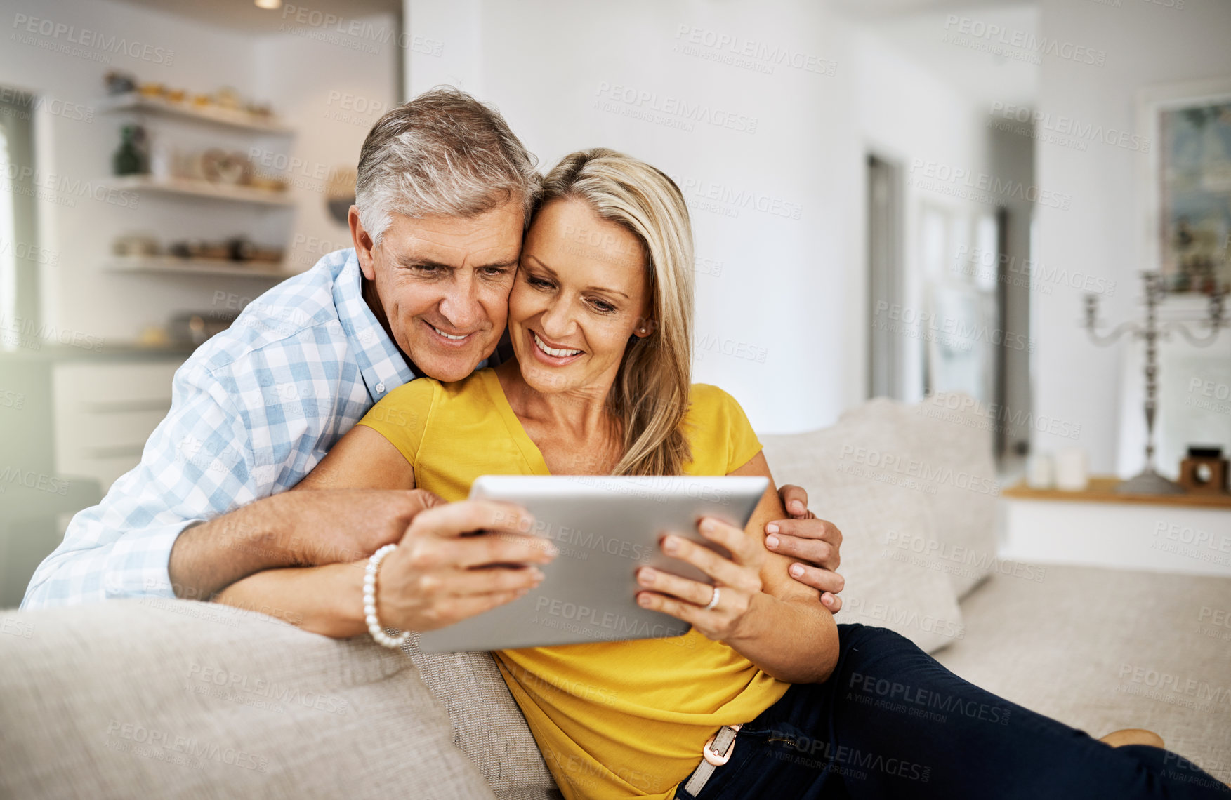 Buy stock photo Couple, hug and tablet on sofa for social media, news and online on couch in living room. Technology, internet or app on digital website in home, man or woman mature people in lounge with touchscreen