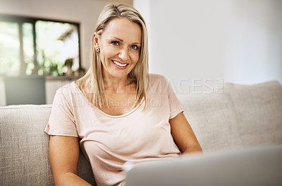 Buy stock photo Cropped shot of a mature woman relaxing on her sofa at home