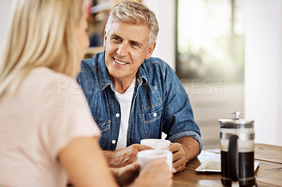 Buy stock photo Cropped shot of a mature couple enjoying some coffee in the morning