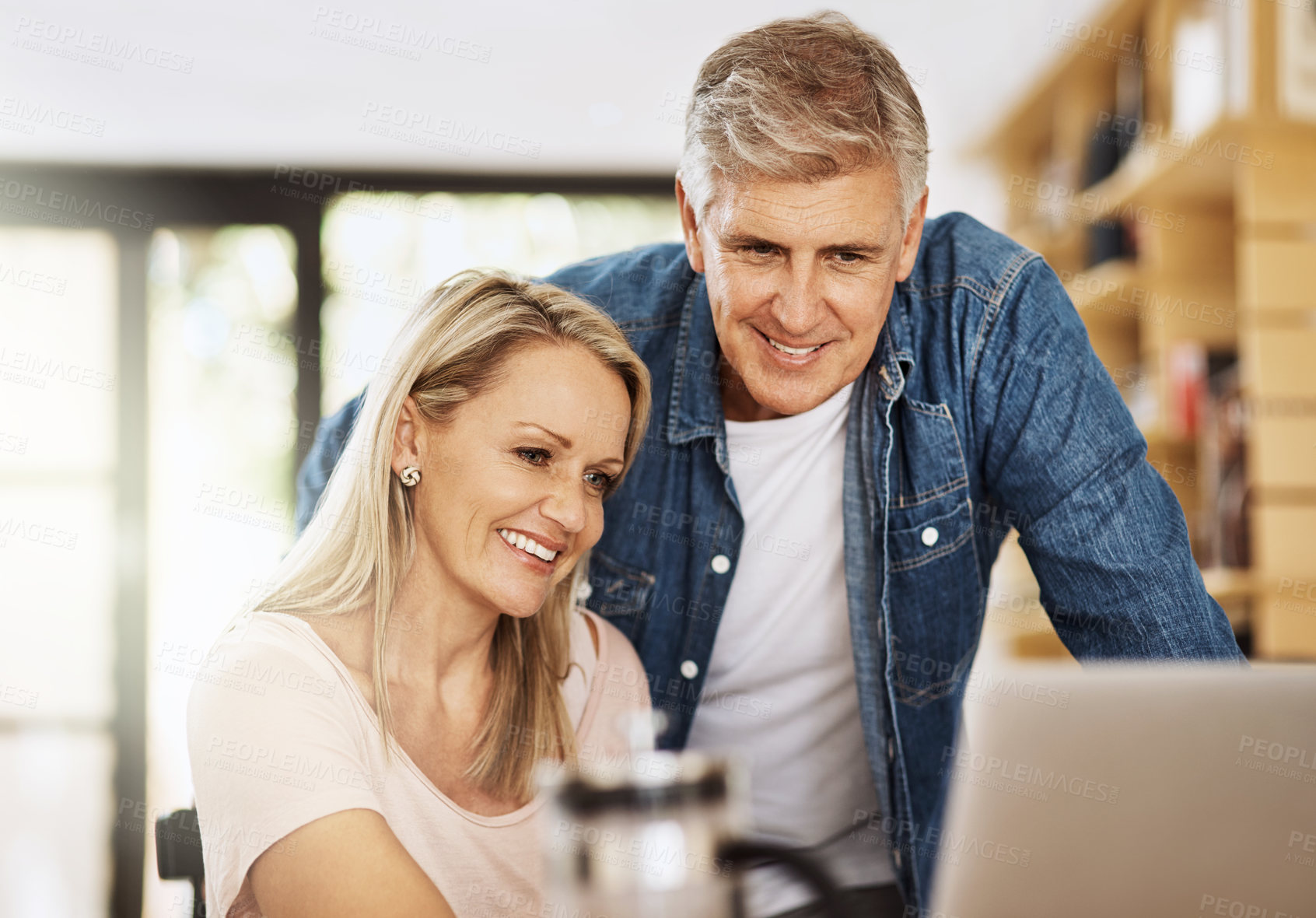 Buy stock photo Mature, couple and together with laptop in home for social media, happy for video call on internet app. People, house or computer with connection for online news with happiness, relax with technology