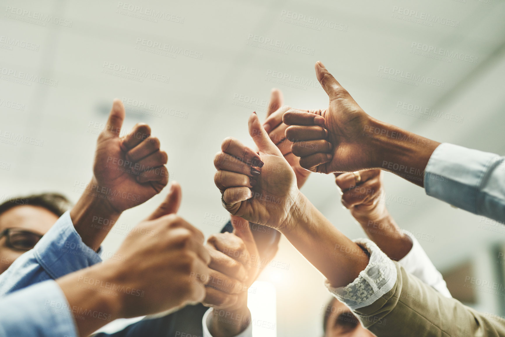 Buy stock photo Shot of a group of unrecognisable businesspeople showing thumbs up in an office