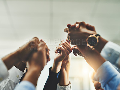 Buy stock photo Shot of a group of unrecogniasble businesspeople holding hands in unity in an office