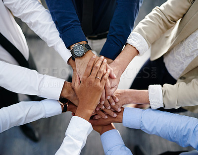 Buy stock photo Shot of a group of unrecognisable businesspeople joining their hands together in unity in an office