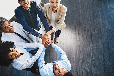 Buy stock photo Portrait of a group of businesspeople joining their hands together in unity in an office