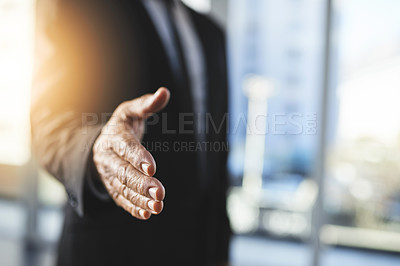 Buy stock photo Shot of an unrecognisable businessman extending a handshake in an office