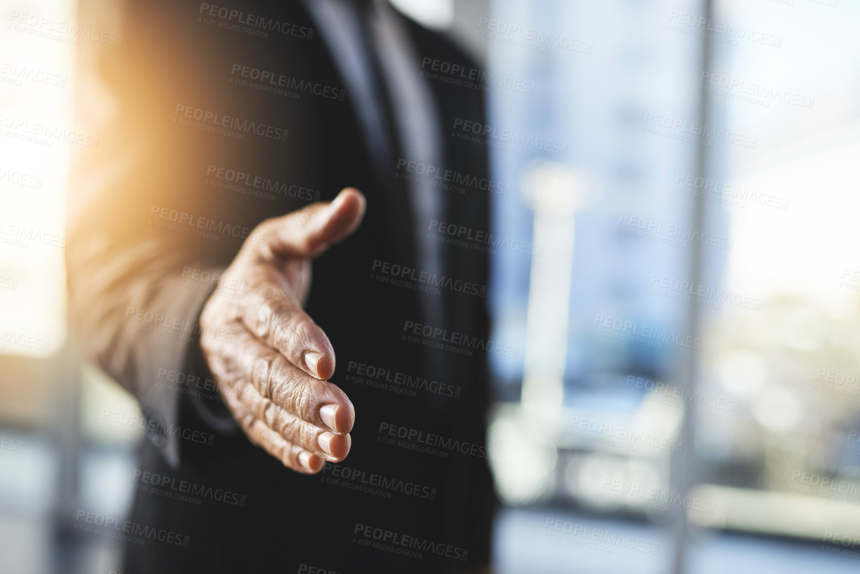 Buy stock photo Shot of an unrecognisable businessman extending a handshake in an office