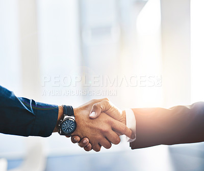 Buy stock photo Shot of two unrecognisable businesspeople shaking hands in an office