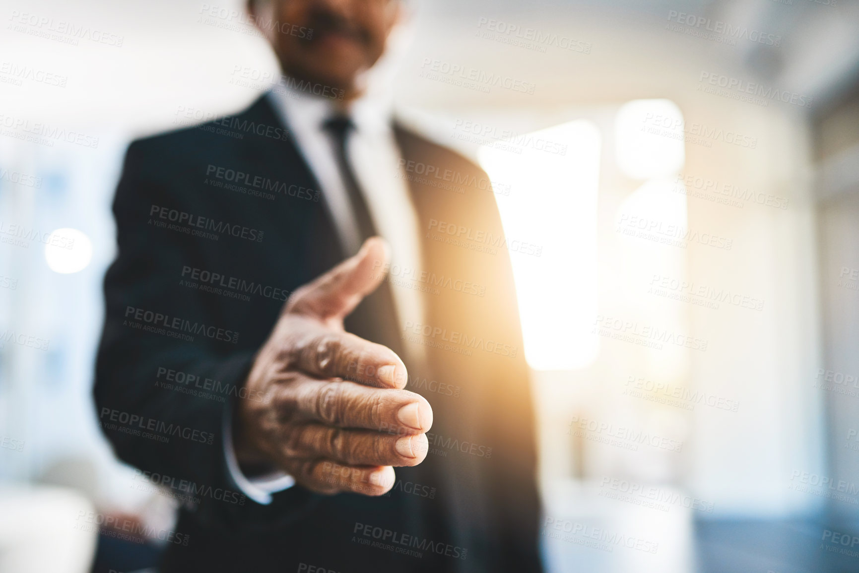 Buy stock photo Shot of an unrecognisable businessman extending a handshake in an office