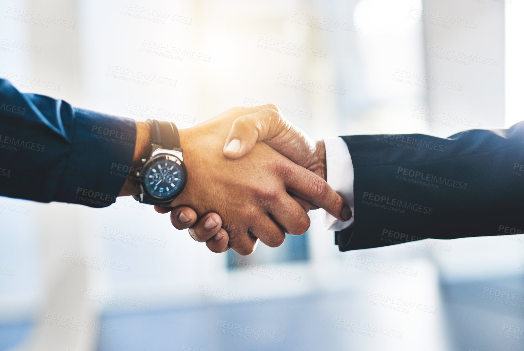 Buy stock photo Shot of two unrecognisable businesspeople shaking hands in an office