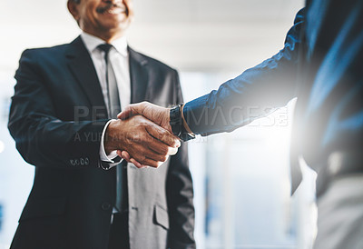 Buy stock photo Shot of two unrecognisable businesspeople shaking hands in an office