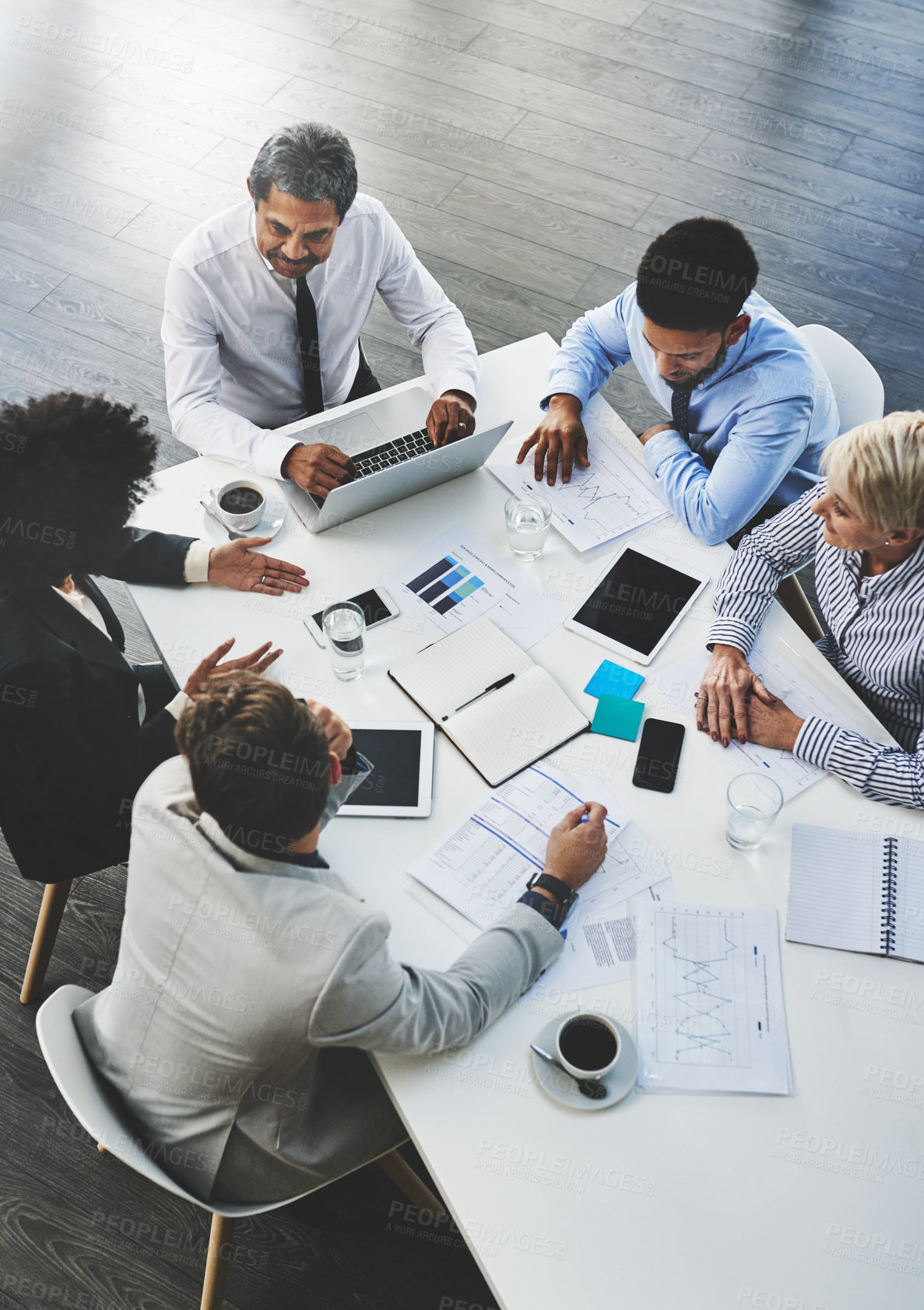 Buy stock photo Shot of a group of businesspeople having a meeting in an office