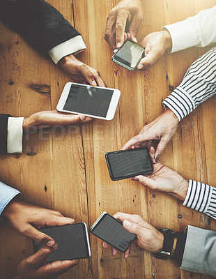 Buy stock photo Shot of a group of unrecognisable businesspeople using their cellphones in synchronicity