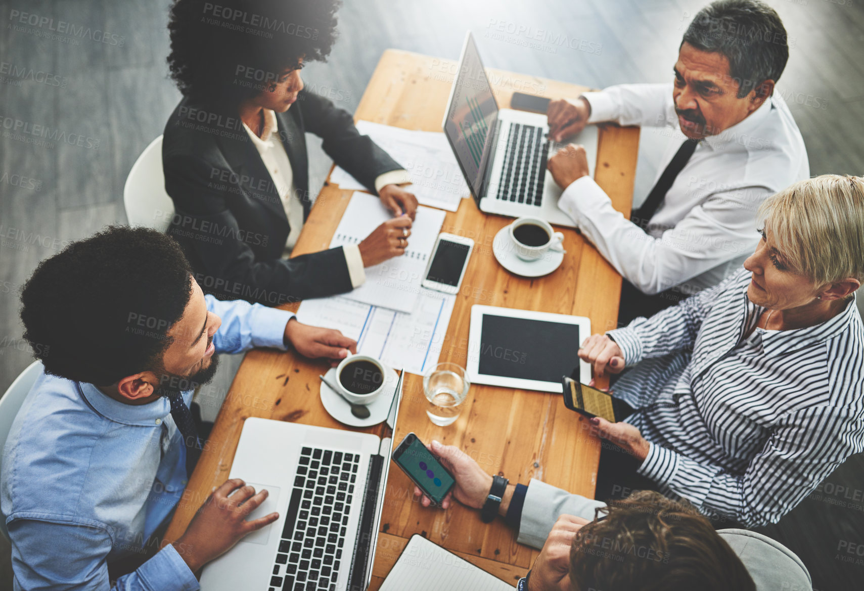 Buy stock photo Shot of a group of businesspeople having a meeting in an office